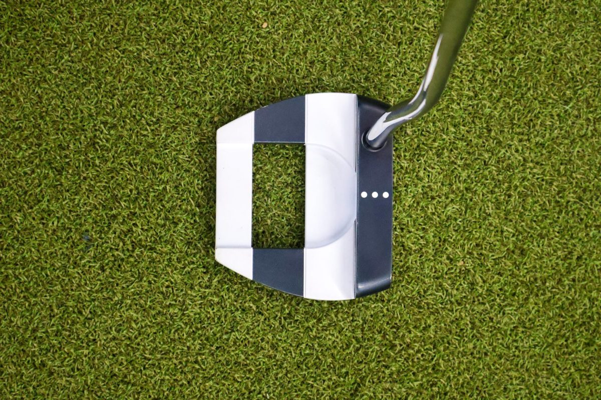 Golf putter on turf during a product photography shoot by Jubilee