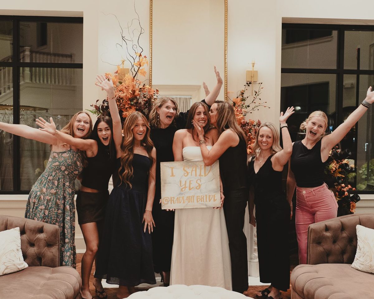 Bride and bridesmaids celebrating inside the Radiant Bride boutique