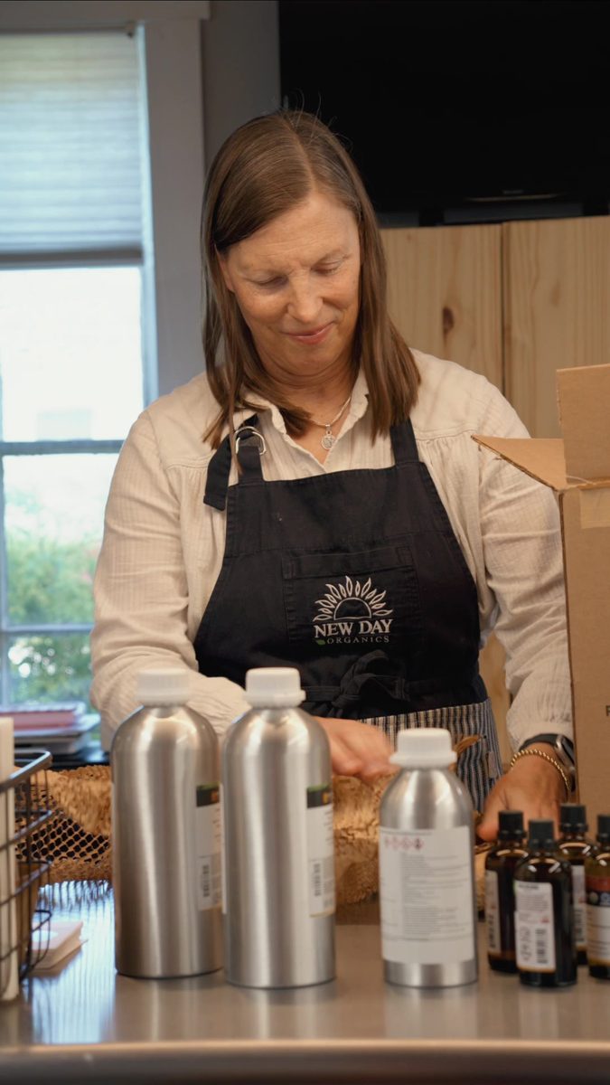 New Day Organics owner preparing products behind the counter
